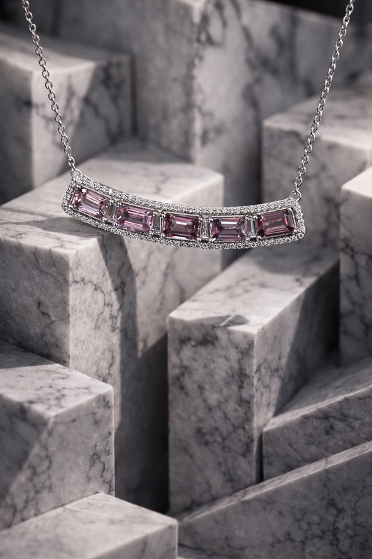 14K white gold curved pink sapphire bar necklace with 2.9 carat emerald cut sapphires and 0.5 carat diamond halo setting