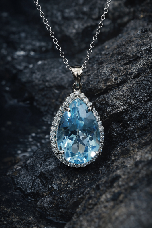 Pear shape blue topaz halo pendant in 14K white gold with 0.27 carat G-H SI diamond accents Houston jewelry store Endless Diamonds