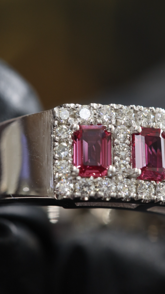 Crimson Gallery Ruby Eternity Band in White Gold | Emerald-Cut Rubies with Diamond Halo Rows