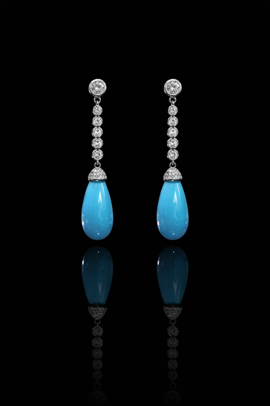 14K white gold diamond drop earrings with pear-shaped blue tourmaline gemstones and bezel-set diamond chain